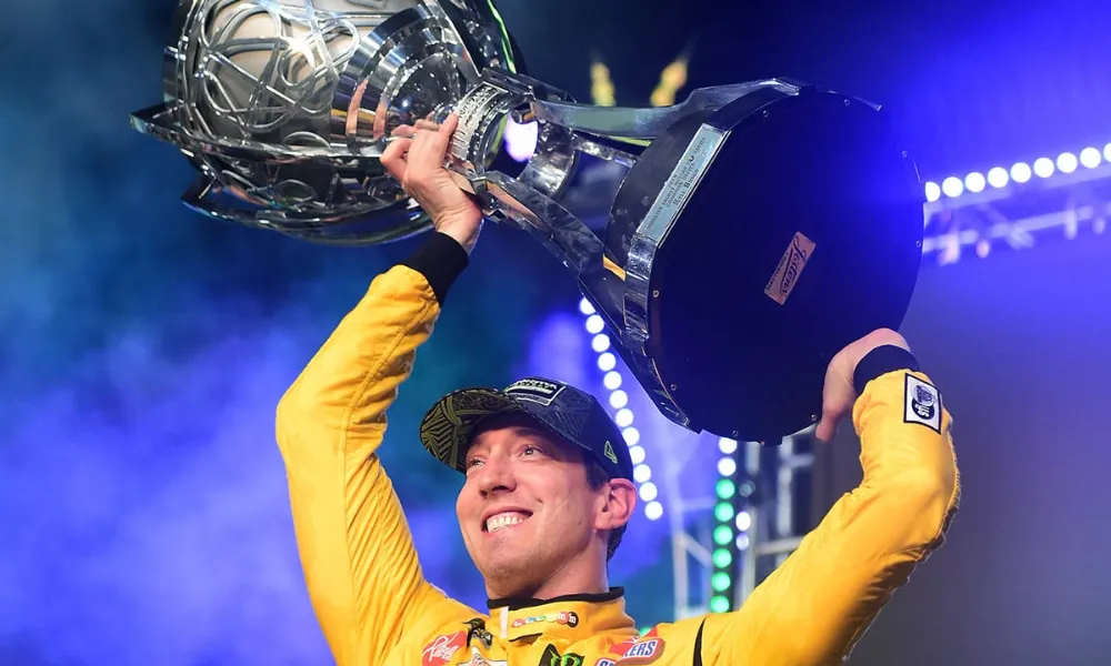 Kyle Busch celebrating with his NASCAR Cup Series championship trophy