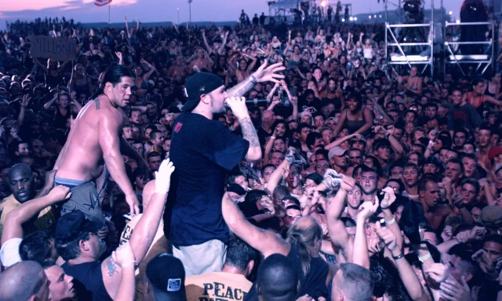 Facezem | Fred Durst Net Worth: How the Limp Bizkit Frontman Built His Fortune, Career and Legacy Fred Durst surrounded by a massive crowd during a live music festival performance