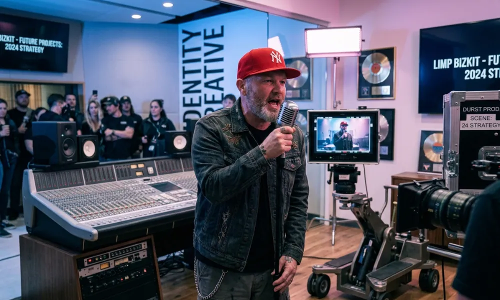 Facezem | Fred Durst Net Worth: How the Limp Bizkit Frontman Built His Fortune, Career and Legacy Fred Durst holding a vintage microphone inside a recording room
