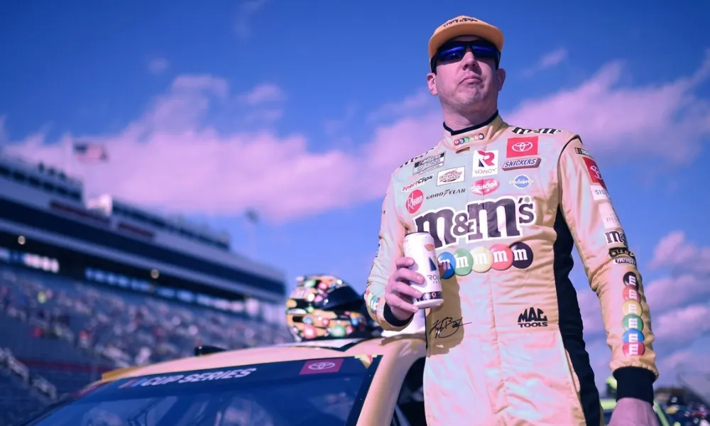 Kyle Busch holding a Rowdy Energy drink on the pit road