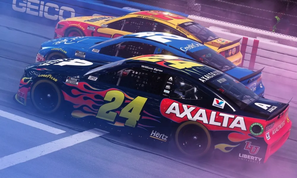 NASCAR Cup Series cars racing closely on track during a event