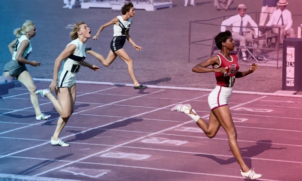 Wilma Rudolph sprinting across the finish line during an Olympic track race.