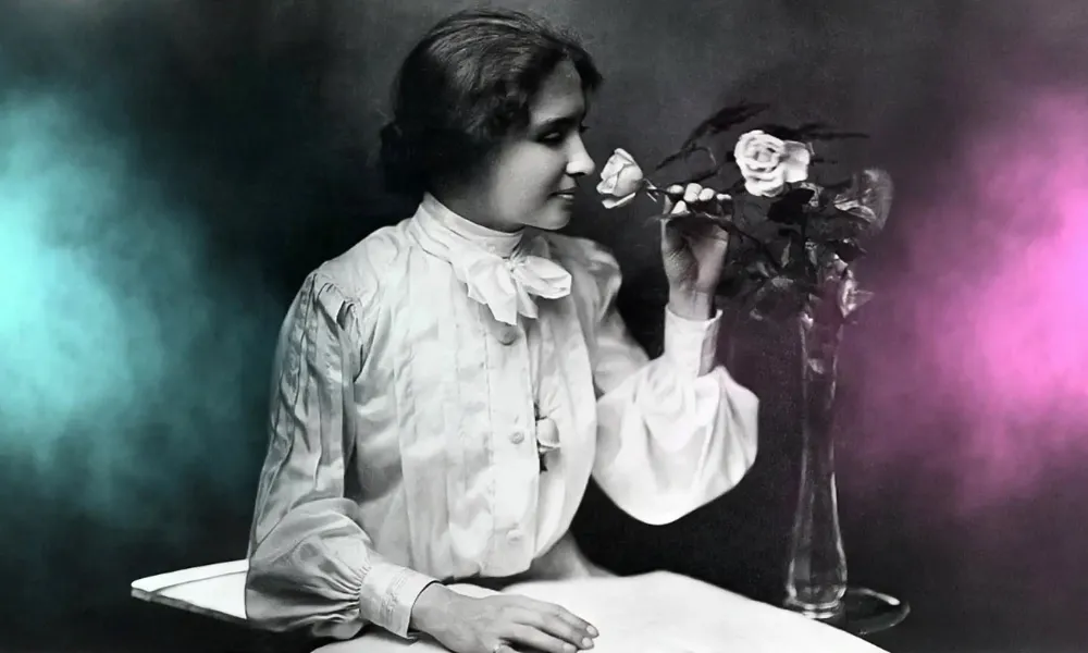 Helen Keller holding a flower-Real Life Inspiring Stories