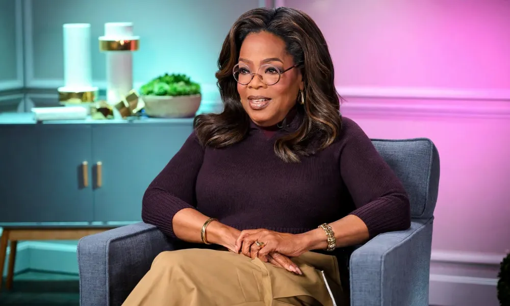 Oprah Winfrey sitting in an armchair during a media interview.
